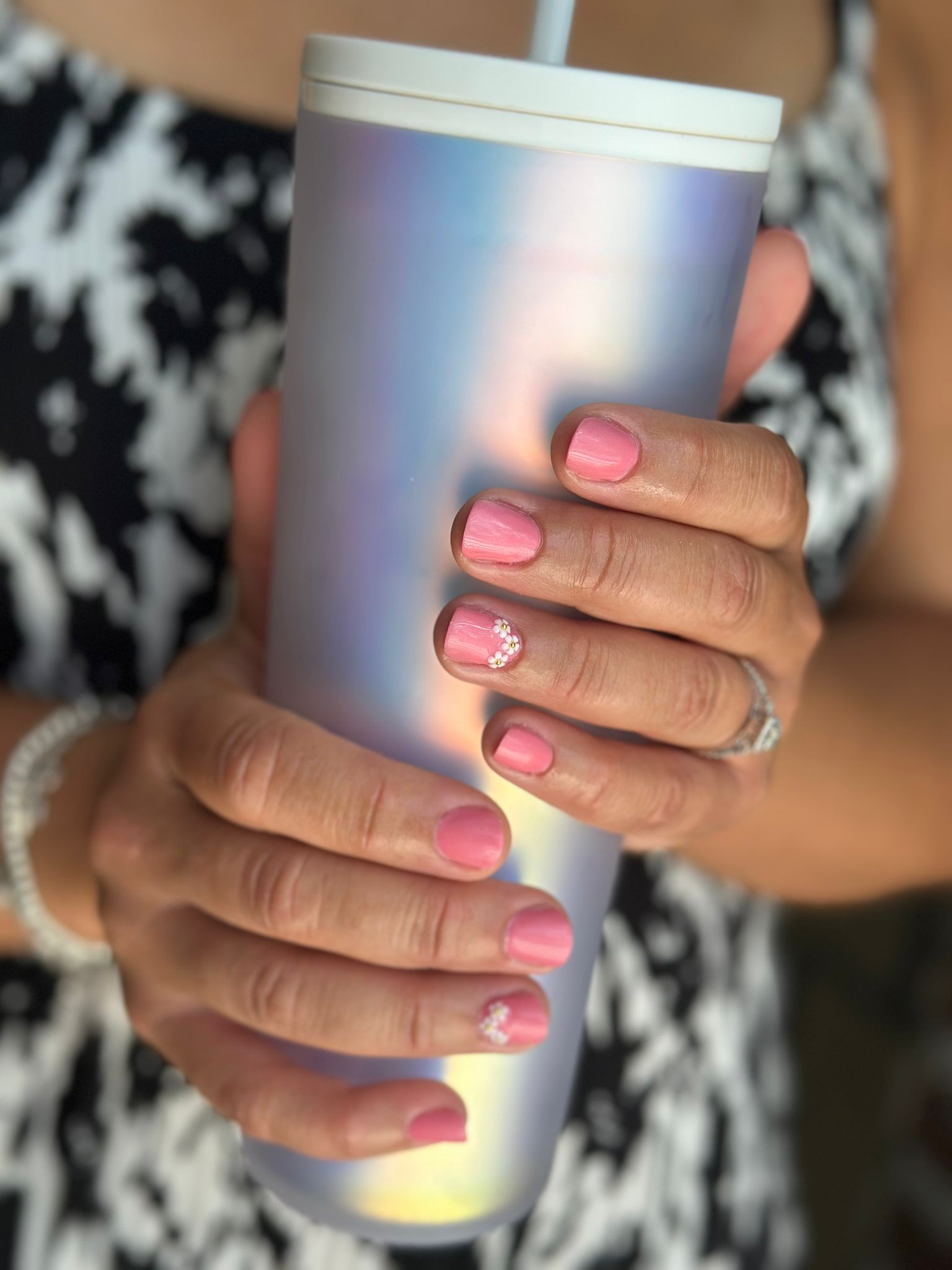 Pink flowers with pearls manicure.